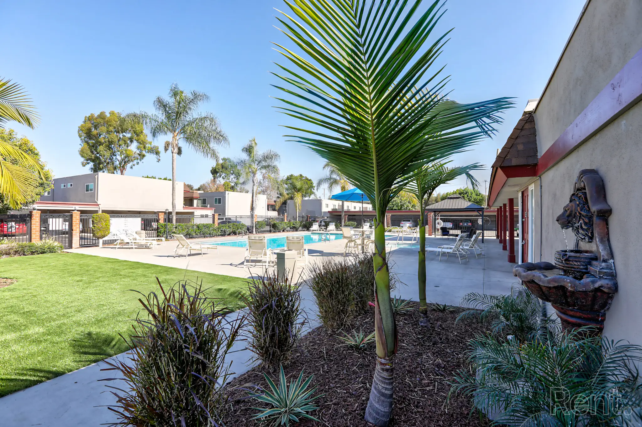Beautifully landscaped exterior pathway leading to the apartment building entrance